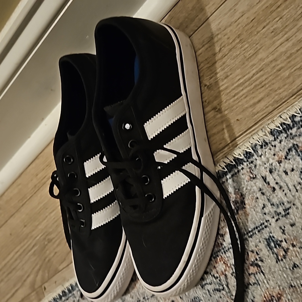 Black & white Adidas skater shoes.